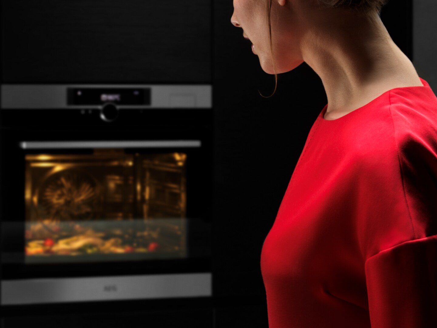 Woman looking at oven