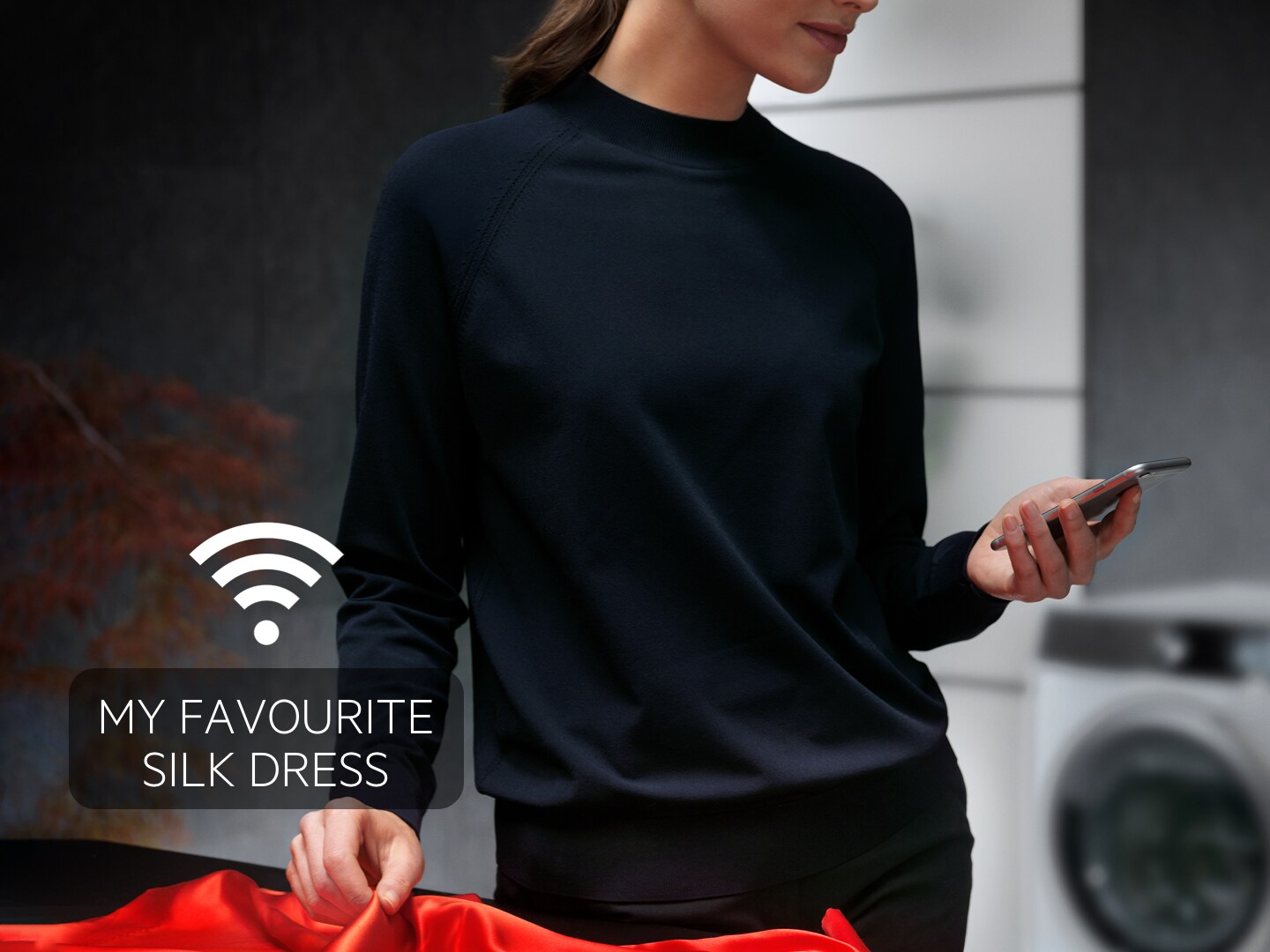Woman with phone with AEG Care app